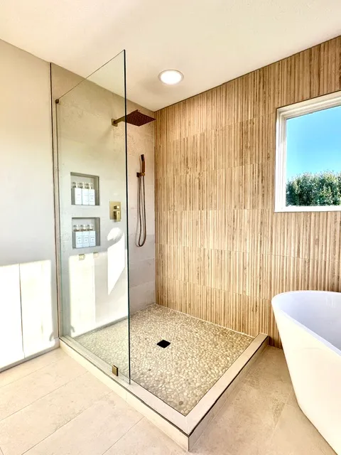 Travertine shower next to a soaking tub
