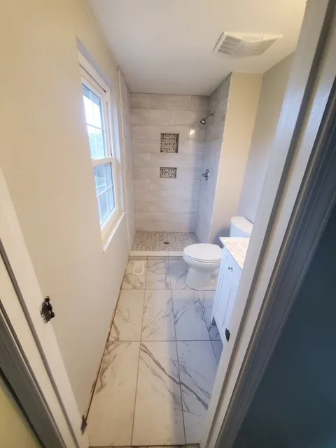 White marble bathroom with a glass shower