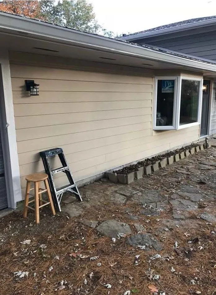 New siding wrapping a bay window on a house elevation