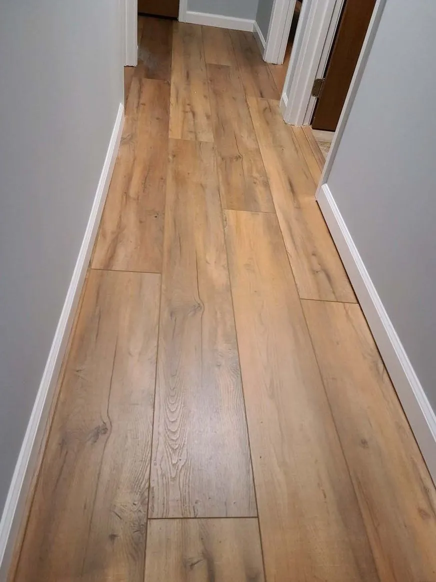 Wide oak plank flooring running the length of a hallway