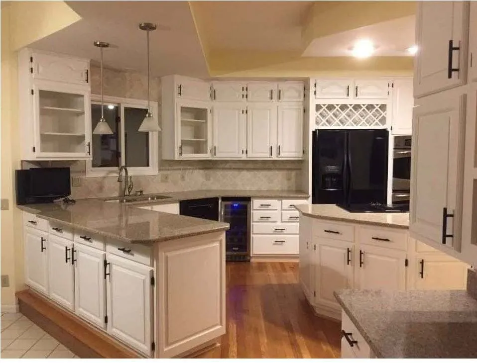 Kitchen cabinets repainted white with new hardware fitted