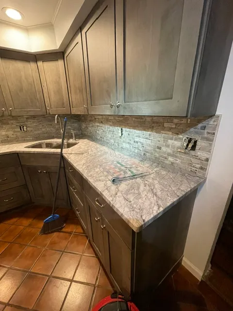 Dark kitchen cabinets under a granite counter
