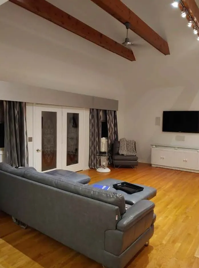 Living room with exposed timber beams across the ceiling