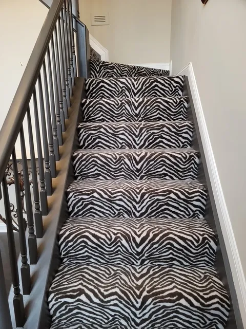 Staircase with a zebra-pattern runner